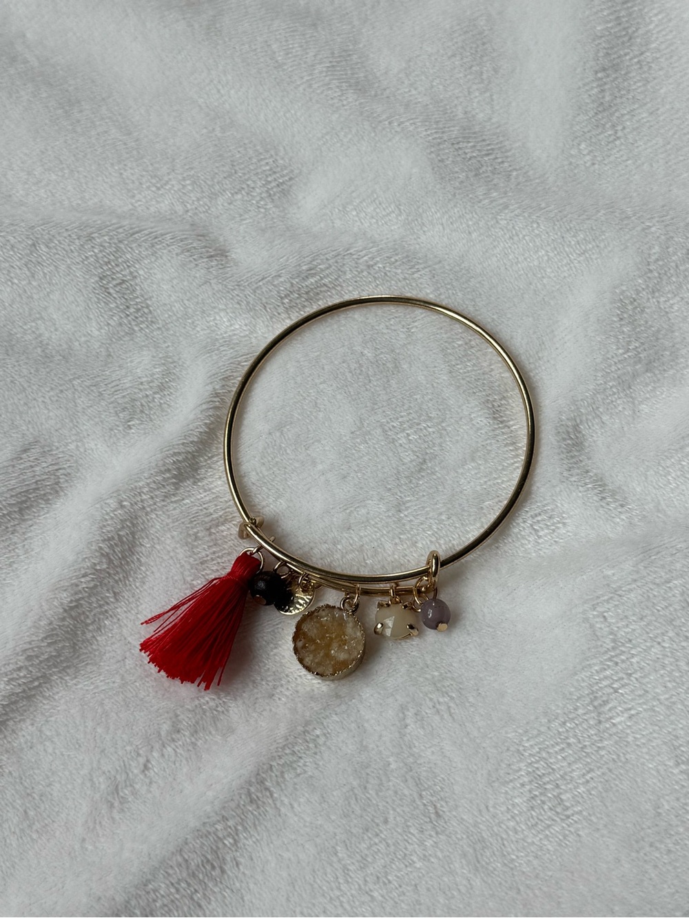 Gold Tone Bangle Bracelet with Red Tassel and Gemstone Charms